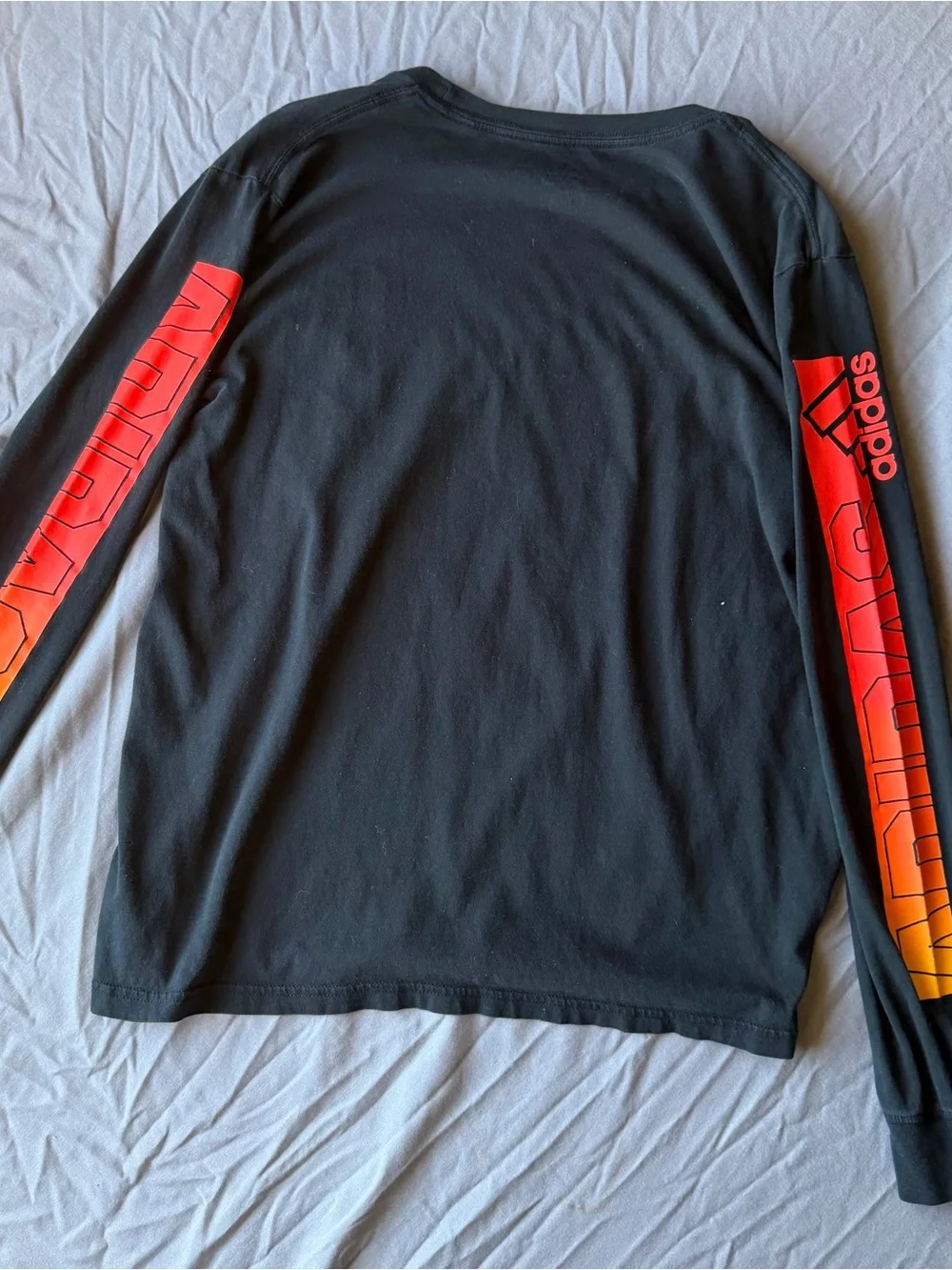 adidas Men’s Black Long-Sleeve Shirt with Red and Yellow Gradient Logo